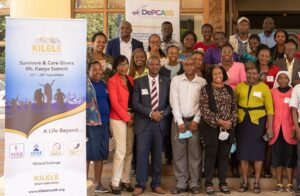 Group photo next to a banner; Prevent Cancer Foundation's global grant recipient, KILELE Health Association 